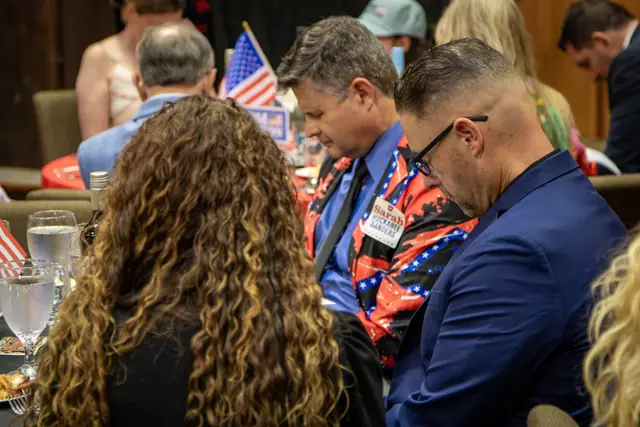 Heads bowed for the invocation