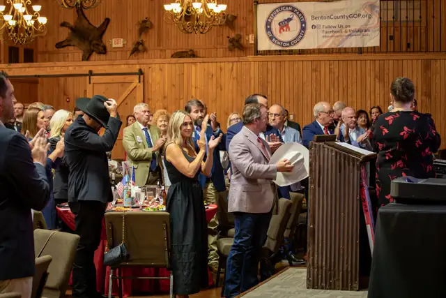 Guests stand for the national anthem