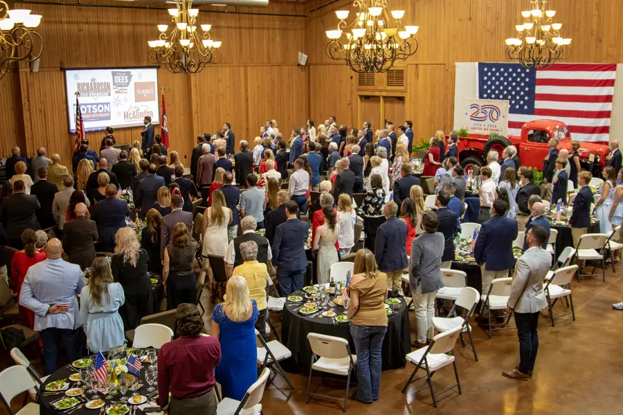 Guests standing at their tables for the Pledge of Allegiance