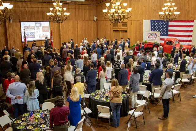 The room rises for the Pledge of Allegiance