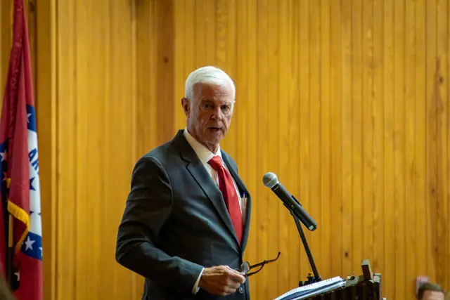 A speaker addresses the dinner