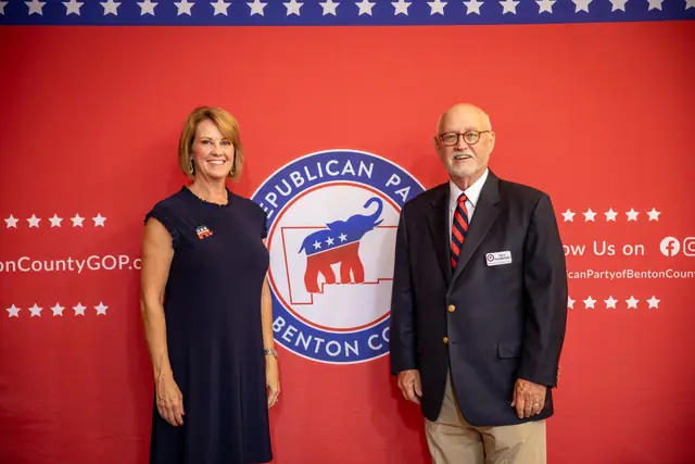 Guests pose at the party backdrop